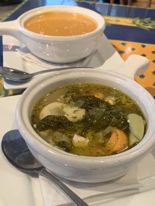 Two crocks of soup, tomato and vegetable